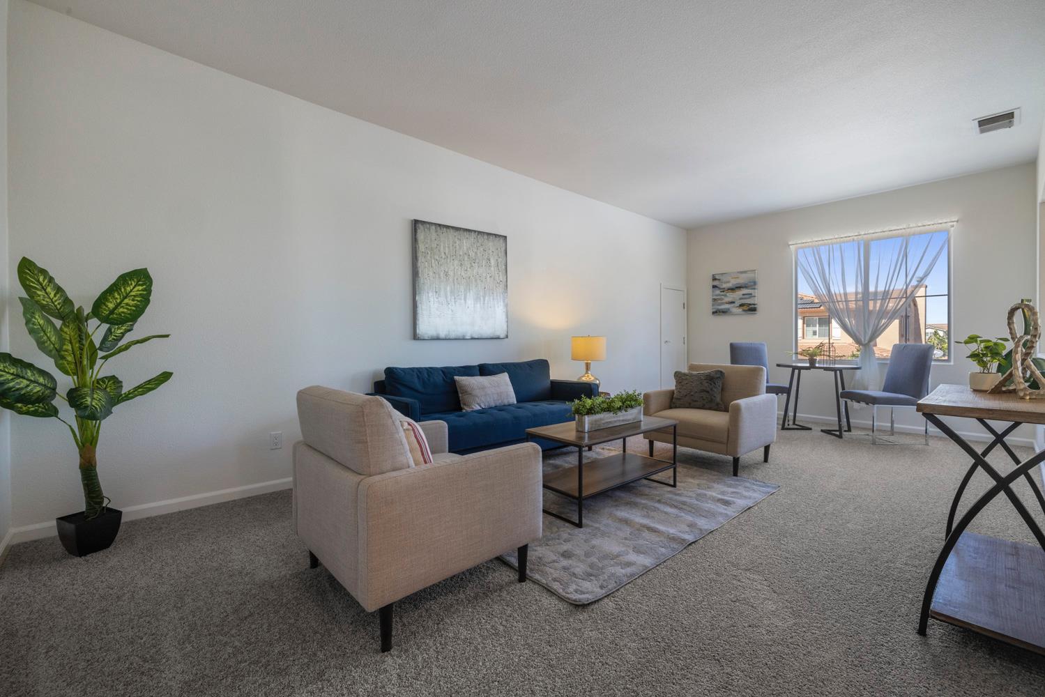481 Keys Court Tracy, CA 95377 - Photo 26 of 45 a living room with furniture a potted plant and a window