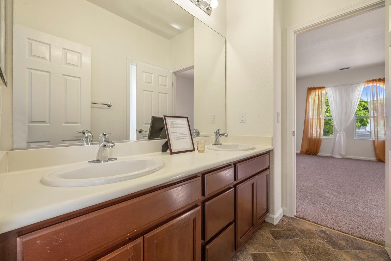 481 Keys Court Tracy, CA 95377 - Photo 33 of 45 a bathroom with a sink and a mirror