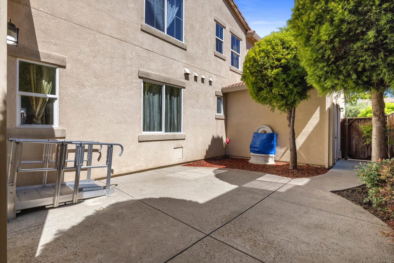 481 Keys Court Tracy, CA 95377 - Photo 38 of 45 a view of a brick house with plants next to a yard