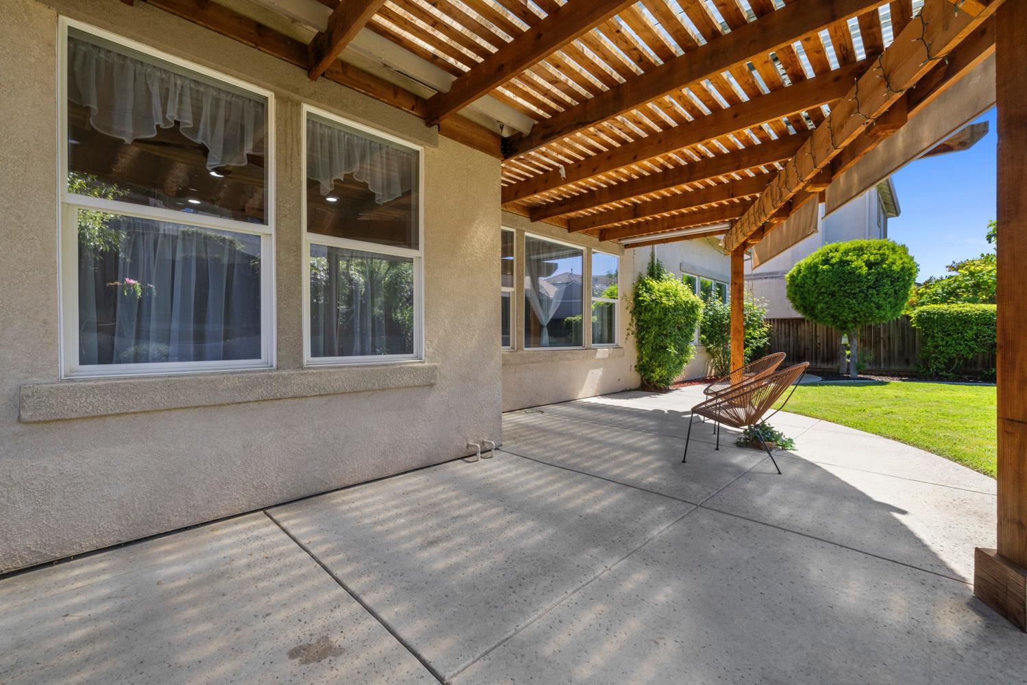 481 Keys Court Tracy, CA 95377 - Photo 40 of 45 a view of a porch with furniture and floor to ceiling window and a yard