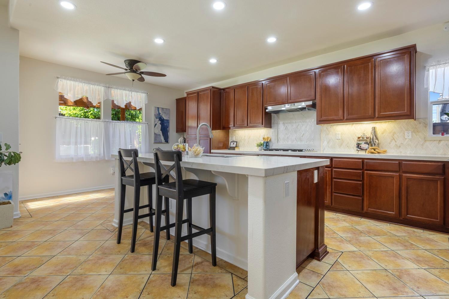 481 Keys Court Tracy, CA 95377 - Photo 7 of 45 a kitchen with stainless steel appliances granite countertop wooden cabinets a stove top oven a sink and dishwasher