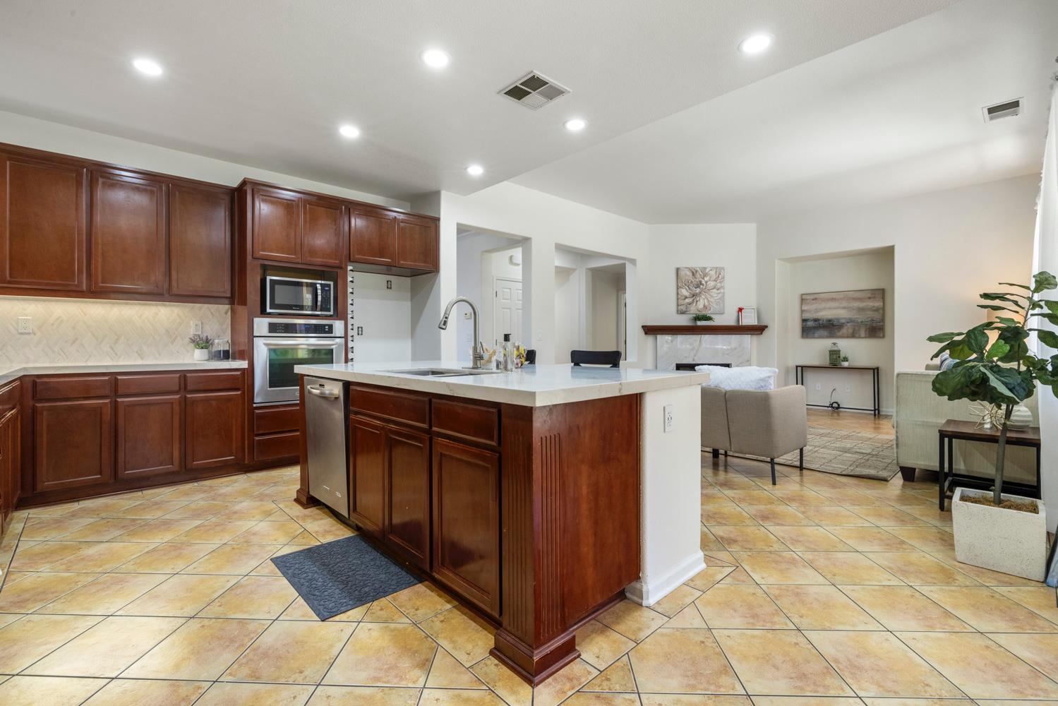 481 Keys Court Tracy, CA 95377 - Photo 10 of 45 a kitchen with stainless steel appliances a sink a counter top space cabinets and a kitchen counter