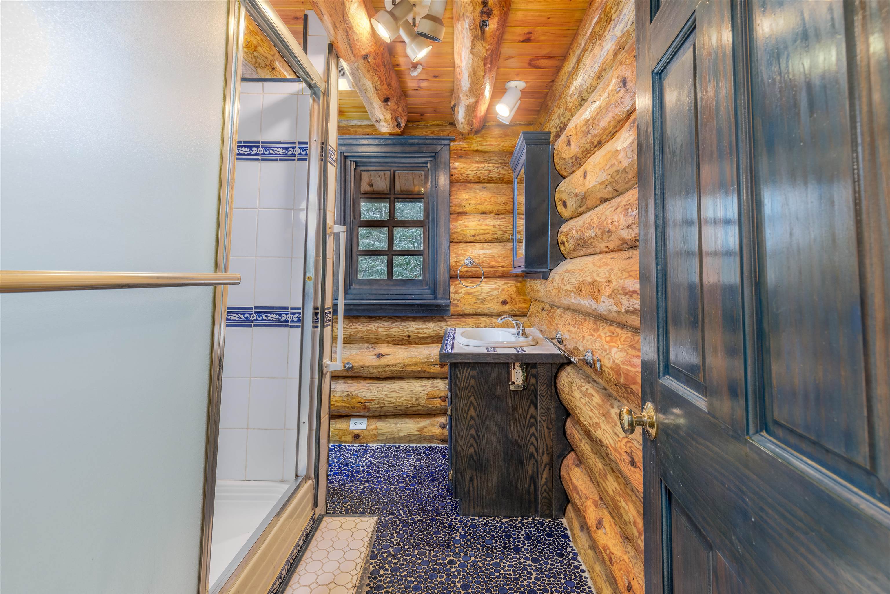 3547 Norway Lane Ely, MN 55731 - Photo 20 of 31 Bathroom featuring vanity, wooden ceiling, walk in shower, log walls, and beamed ceiling