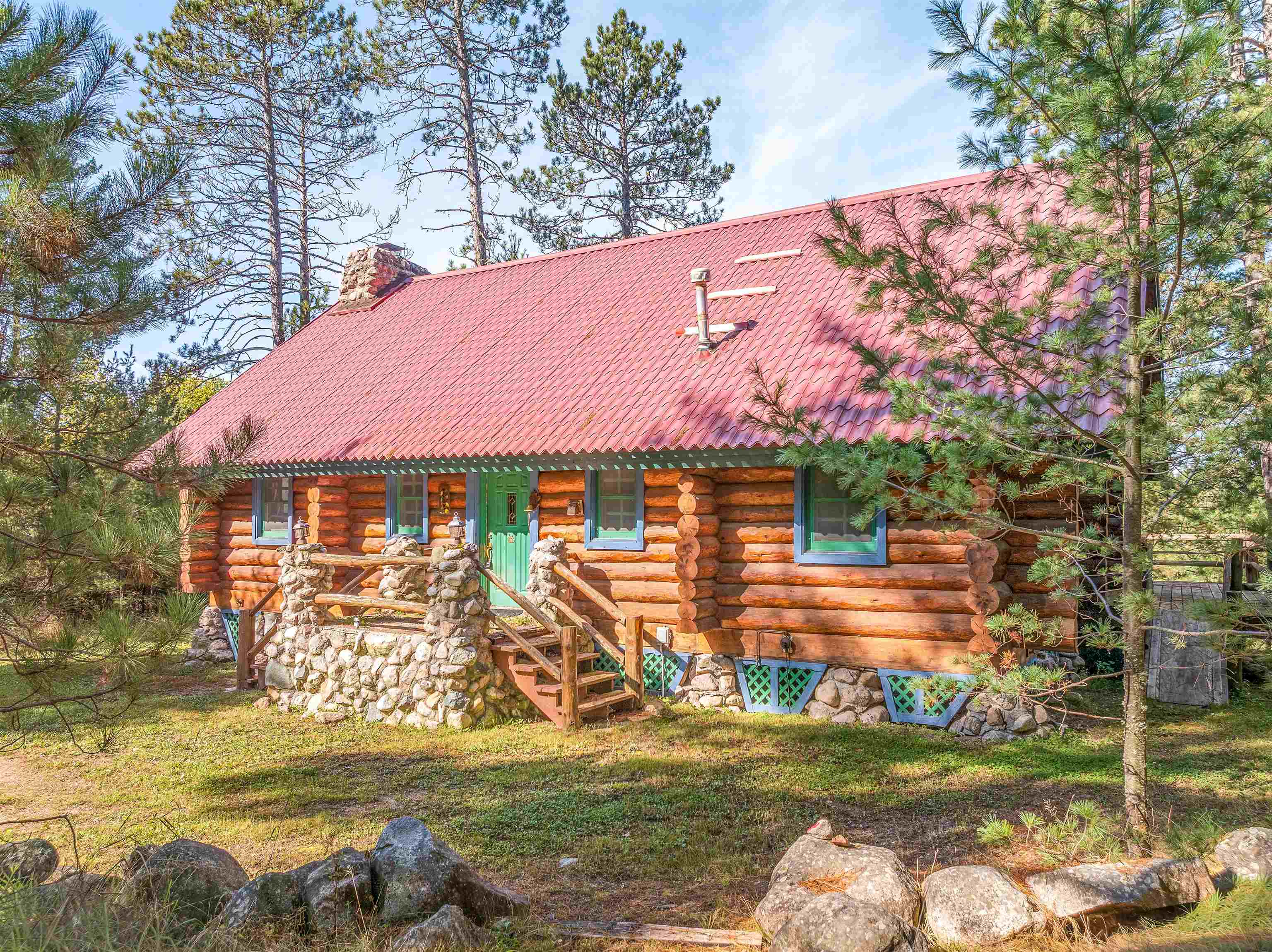 3547 Norway Lane Ely, MN 55731 - Photo 30 of 31 View of front facade featuring a chimney, log siding, and a front yard