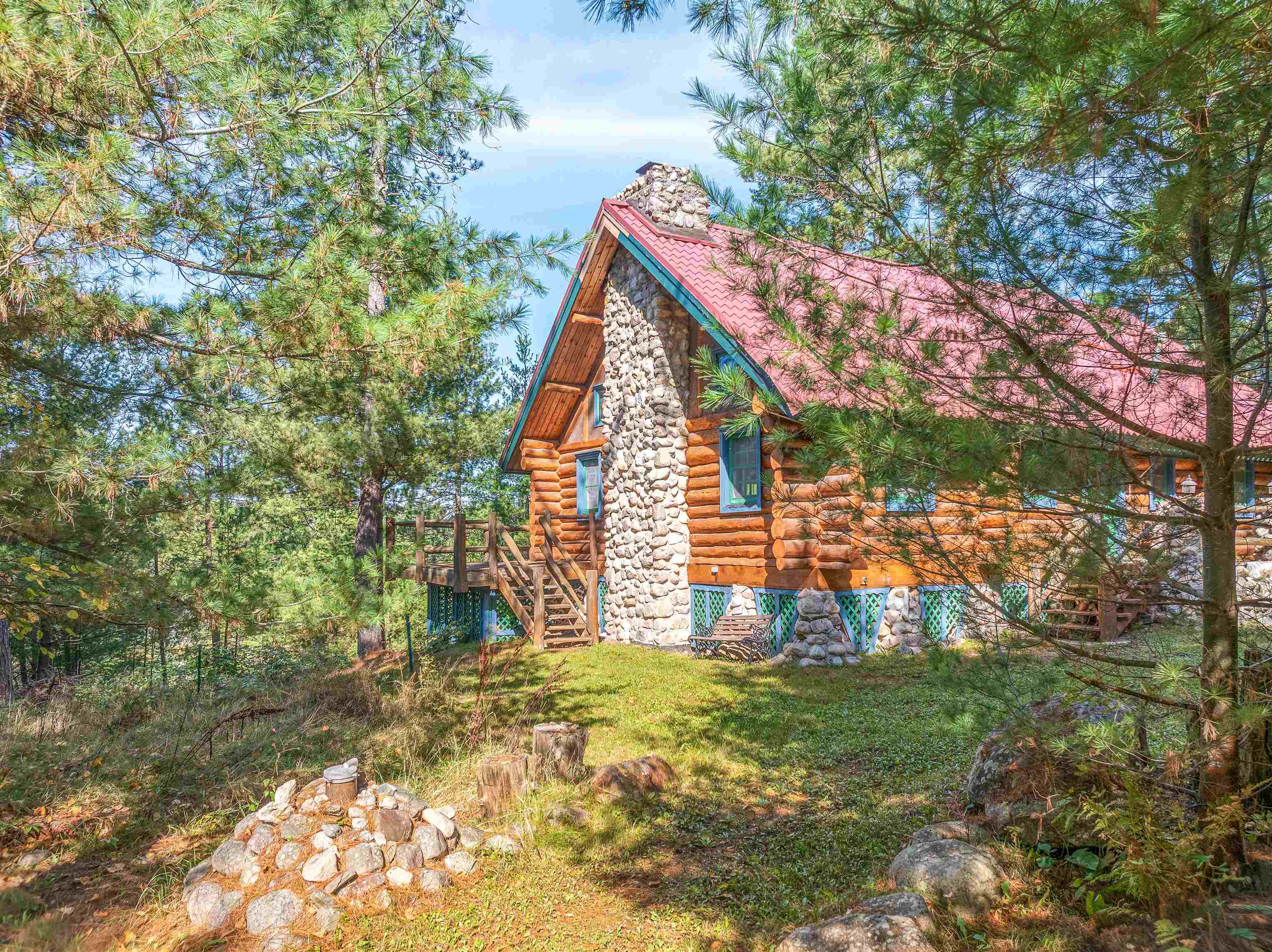 3547 Norway Lane Ely, MN 55731 - Photo 31 of 31 View of side of property featuring log siding, stairway, a chimney, and a lawn