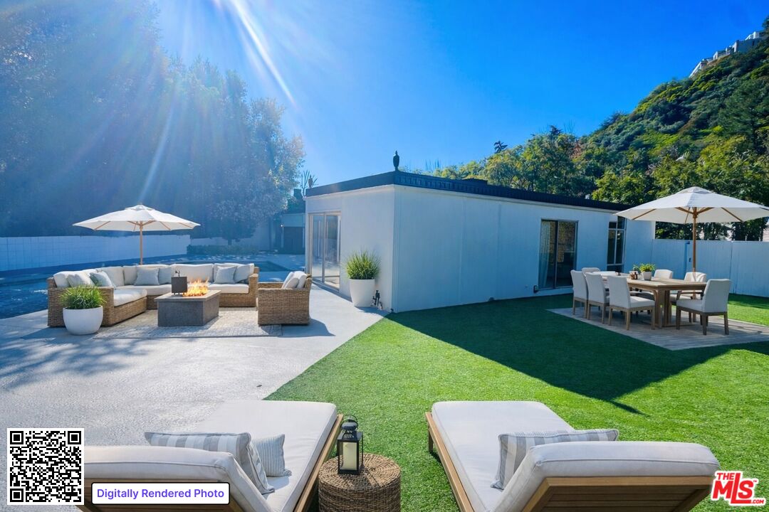 936 Chantilly Road Los Angeles, CA 90077 - Photo 20 of 25 a view of a backyard with furniture and a table and chair