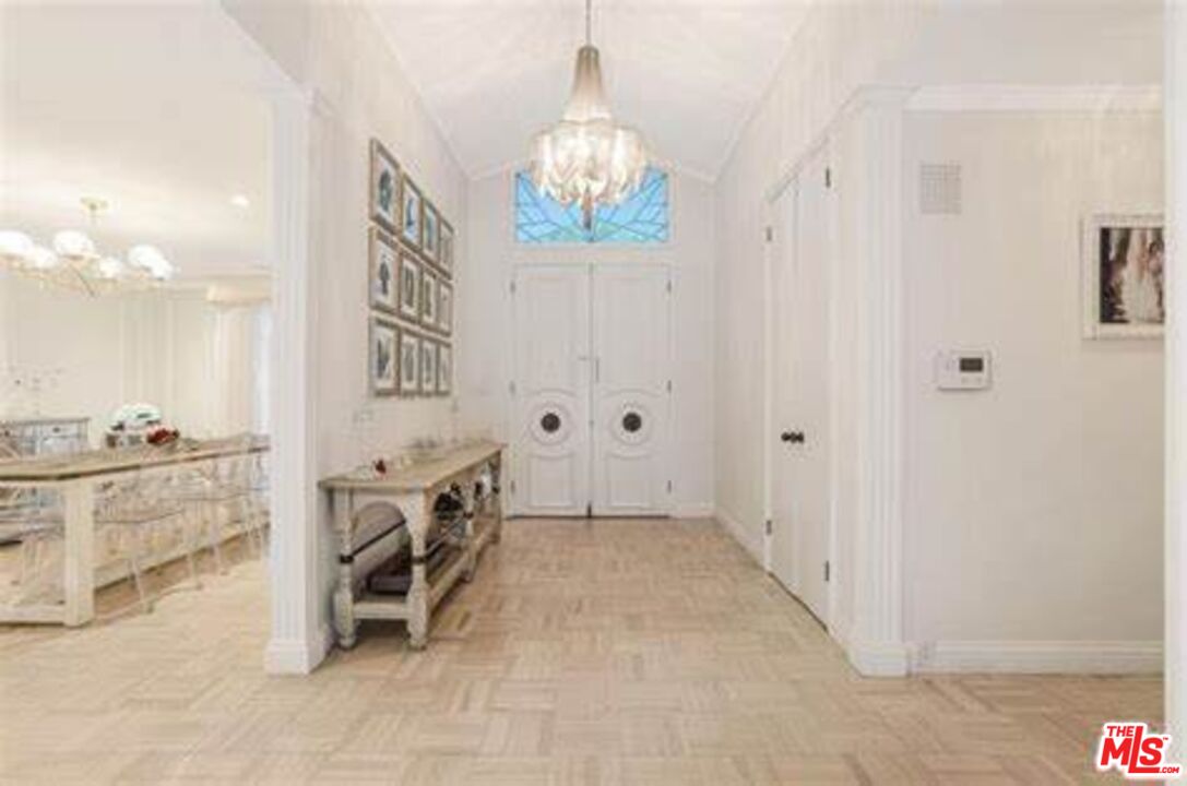 936 Chantilly Road Los Angeles, CA 90077 - Photo 8 of 25 a spacious bathroom with a double vanity sink and a mirror
