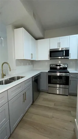 a kitchen with granite countertop a stove and a sink