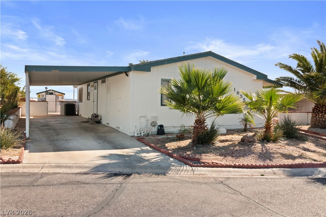 1655 Granada Street Laughlin, NV 89029 - Photo 45 of 76 View of front of house featuring an attached carport and concrete driveway