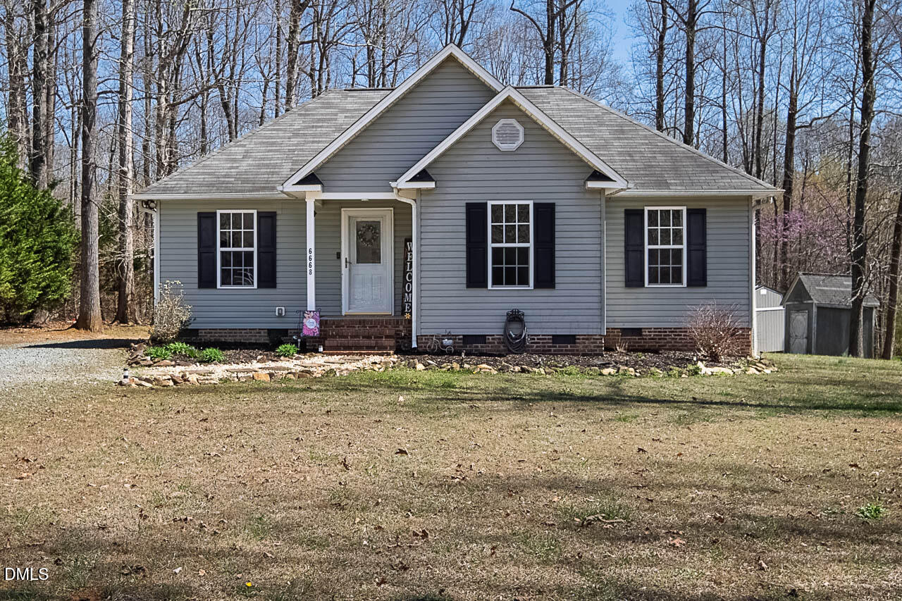 6668 Beaver Ridge Court Snow Camp, NC 27349 - Photo 1 of 38 a front view of a house with a yard