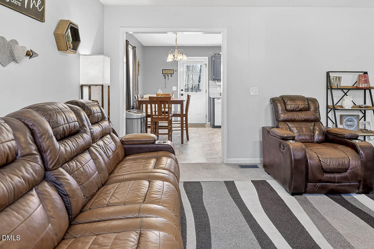 6668 Beaver Ridge Court Snow Camp, NC 27349 - Photo 13 of 38 a living room with furniture and a couch