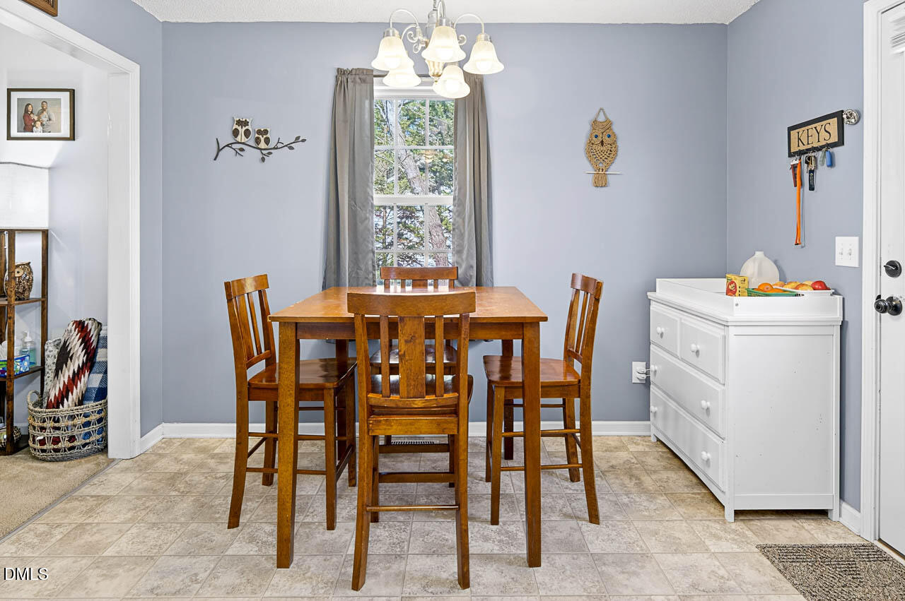 6668 Beaver Ridge Court Snow Camp, NC 27349 - Photo 17 of 38 a dining room with furniture and window