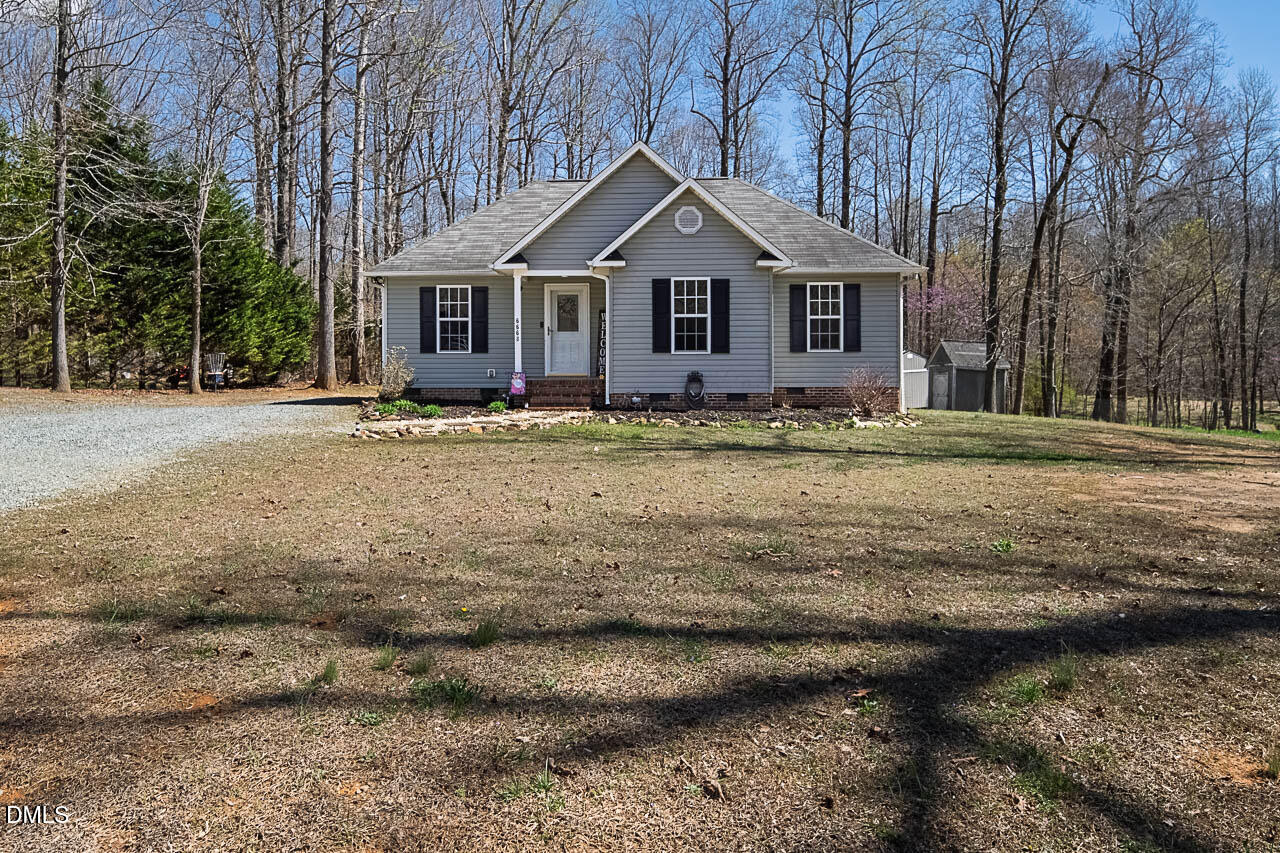 6668 Beaver Ridge Court Snow Camp, NC 27349 - Photo 2 of 38 a front view of a house with a yard