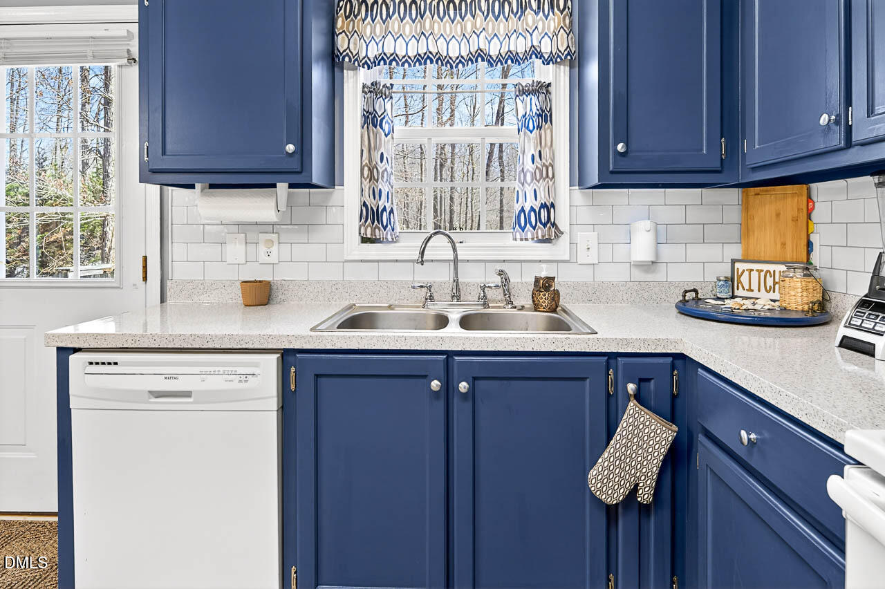 6668 Beaver Ridge Court Snow Camp, NC 27349 - Photo 22 of 38 a kitchen with a sink cabinets and window