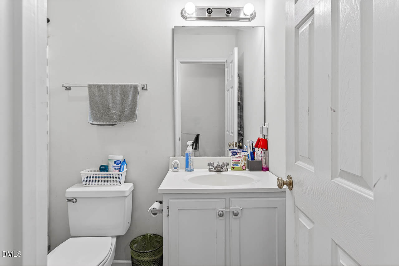 6668 Beaver Ridge Court Snow Camp, NC 27349 - Photo 26 of 38 a bathroom with a sink vanity mirror and toilet