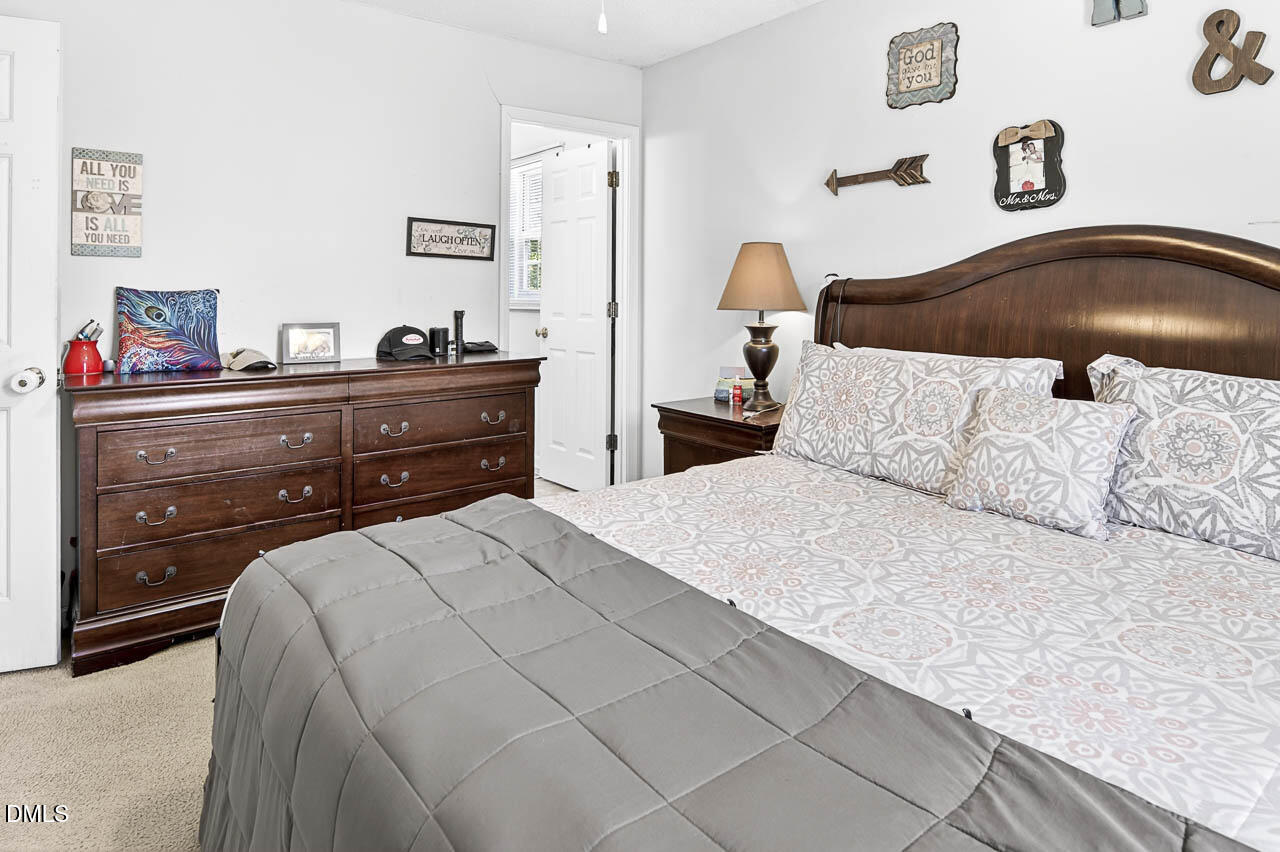 6668 Beaver Ridge Court Snow Camp, NC 27349 - Photo 29 of 38 a bedroom with a bed and a lamp