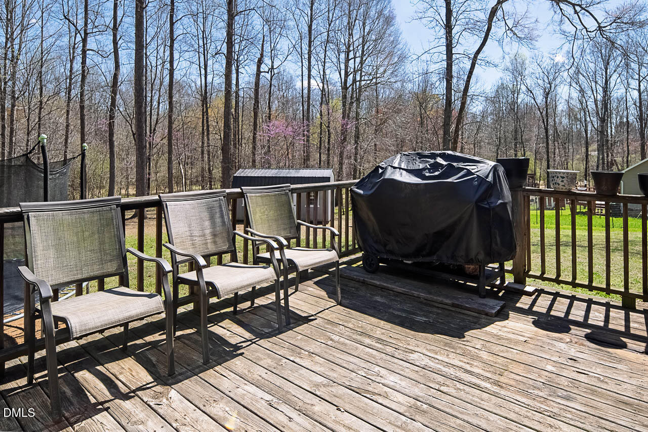 6668 Beaver Ridge Court Snow Camp, NC 27349 - Photo 35 of 38 a view of a balcony with chairs and wooden floor