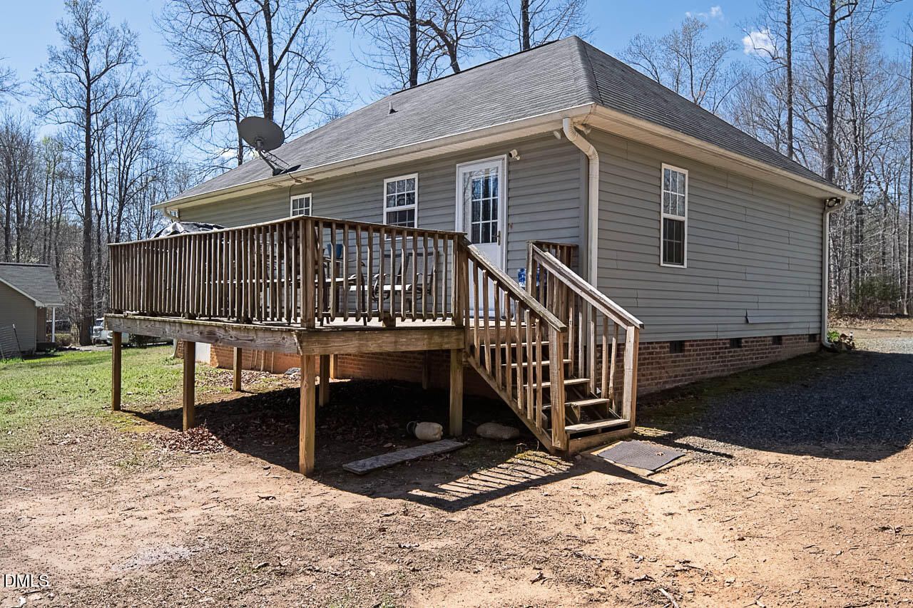 6668 Beaver Ridge Court Snow Camp, NC 27349 - Photo 7 of 38 a view of a house with wooden fence next to a yard