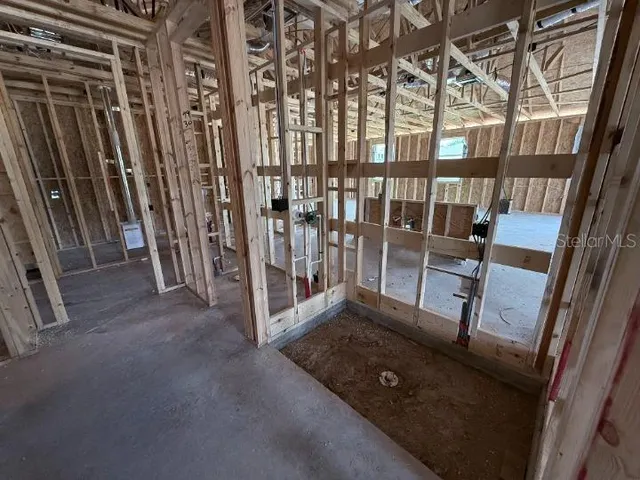 a view of an empty room with staircase