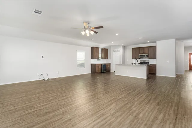 a view of a kitchen with a sink and a large window