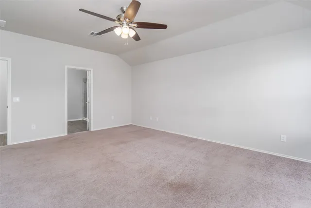a view of an empty room and a ceiling fan
