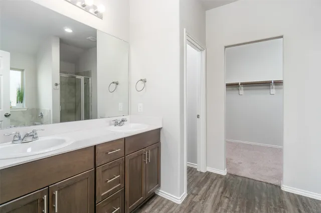 a bathroom with a sink a mirror and a shower