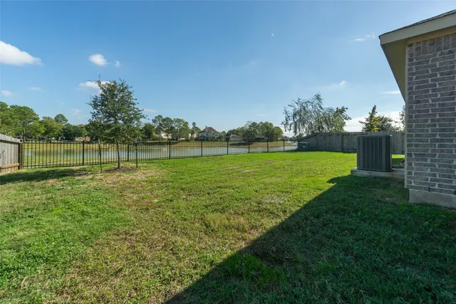 a view of a big yard with a large tree and plants