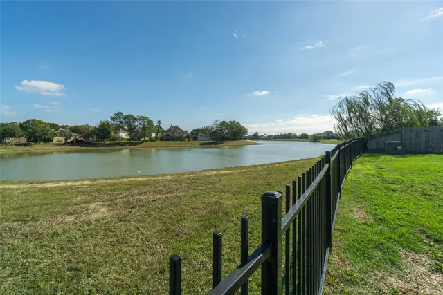 a view of a lake with houses in the back