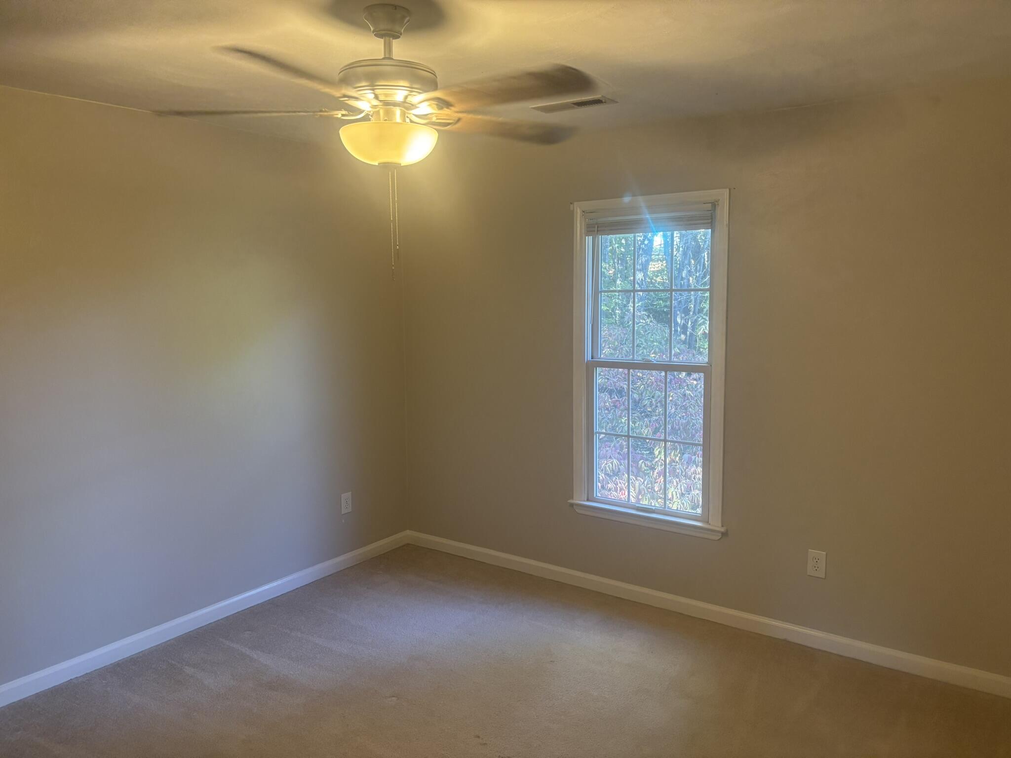 4135 Cresthill Drive Roanoke, VA 24018 - Photo 11 of 13 en empty room with windows and chandelier fan