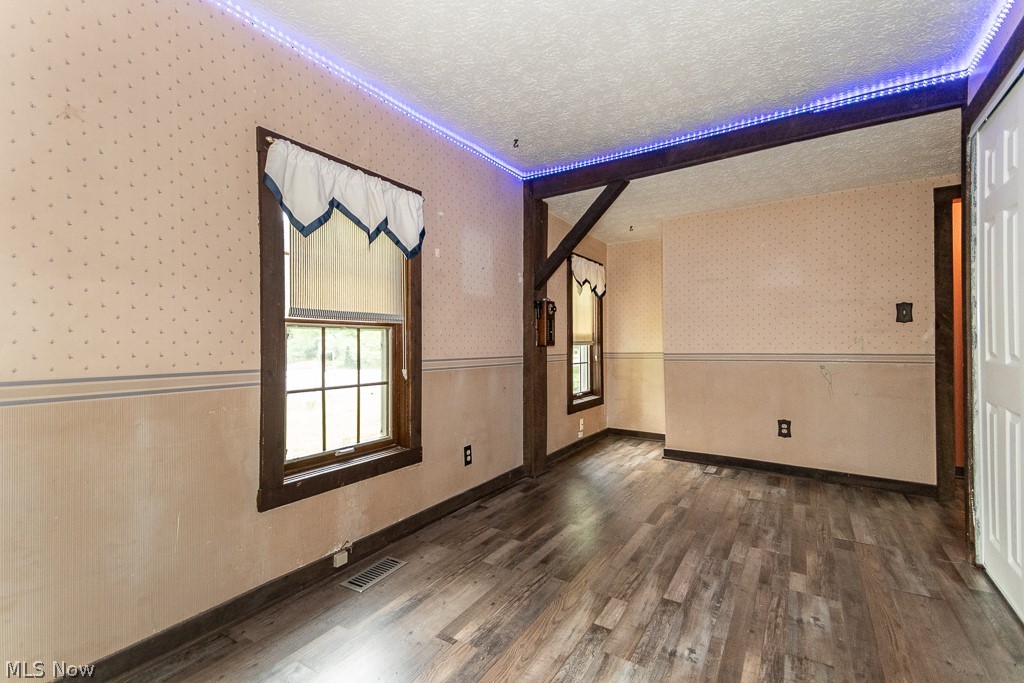 11601 Bass Lake Road Chardon, OH 44024 - Photo 29 of 50 Spare room with dark wood-type flooring and a textured ceiling
