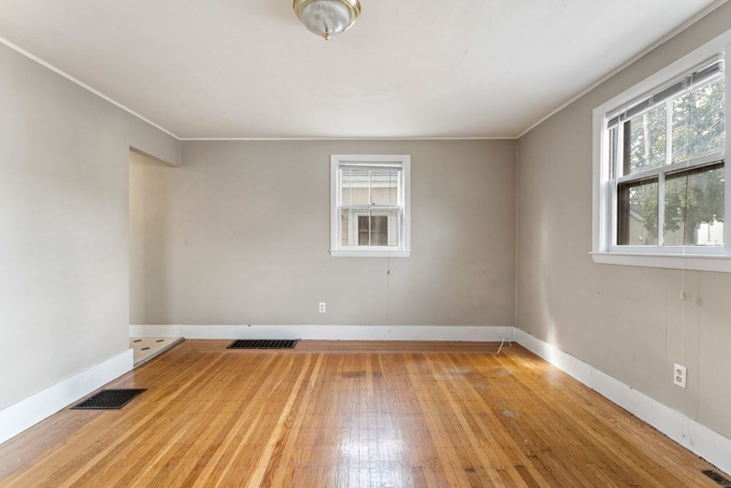 24 School Street Newton, MA 02458 - Photo 12 of 13 an empty room with wooden floor and windows