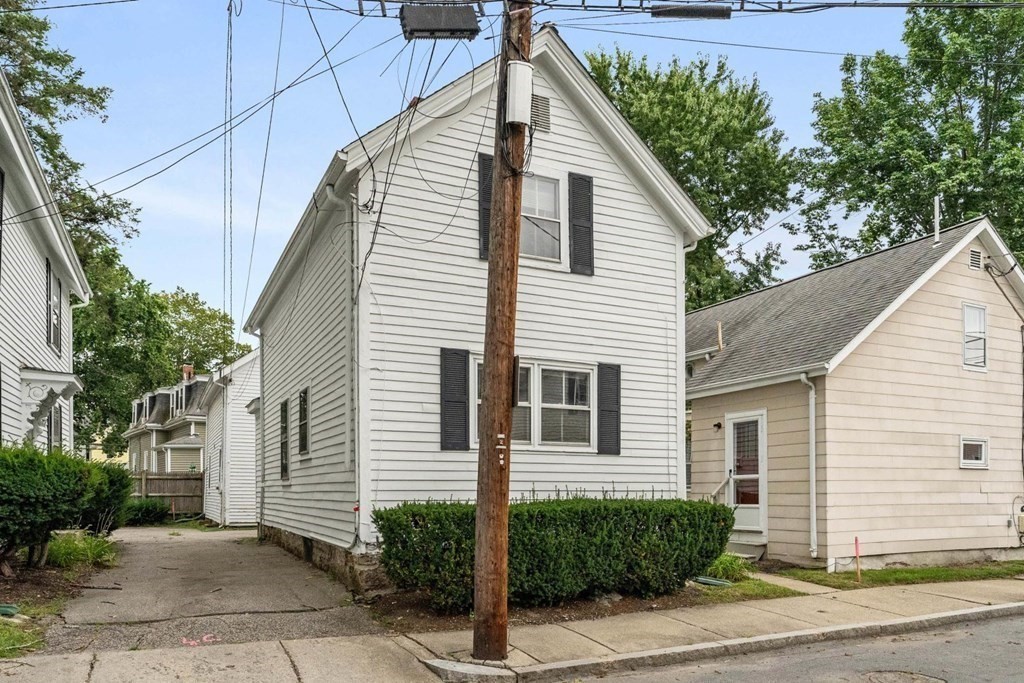 24 School Street Newton, MA 02458 - Photo 3 of 13 a view of a house with a yard