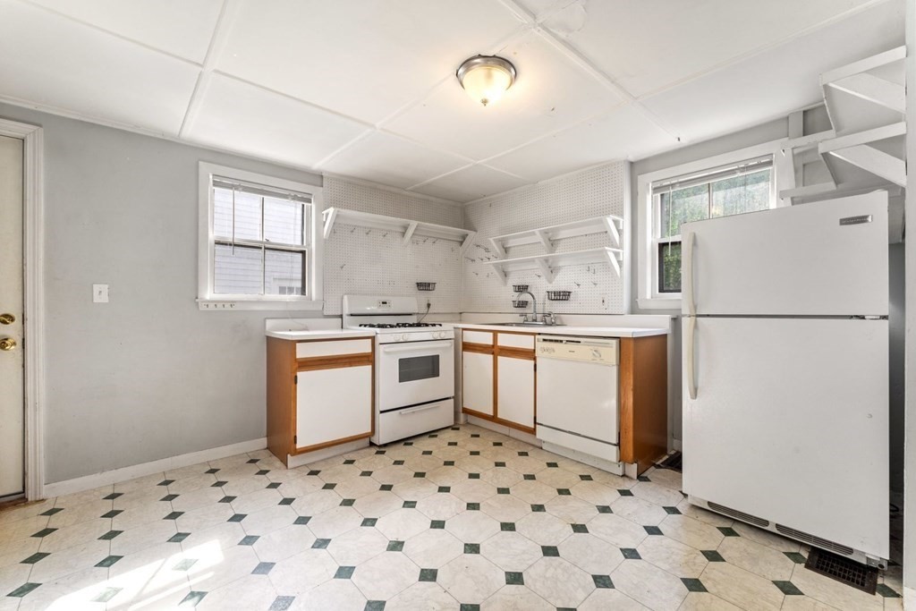 24 School Street Newton, MA 02458 - Photo 4 of 13 a kitchen with a refrigerator a sink and dishwasher