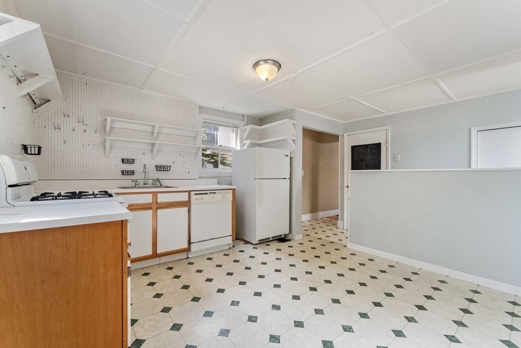 24 School Street Newton, MA 02458 - Photo 5 of 13 a kitchen with a sink a refrigerator and white cabinets