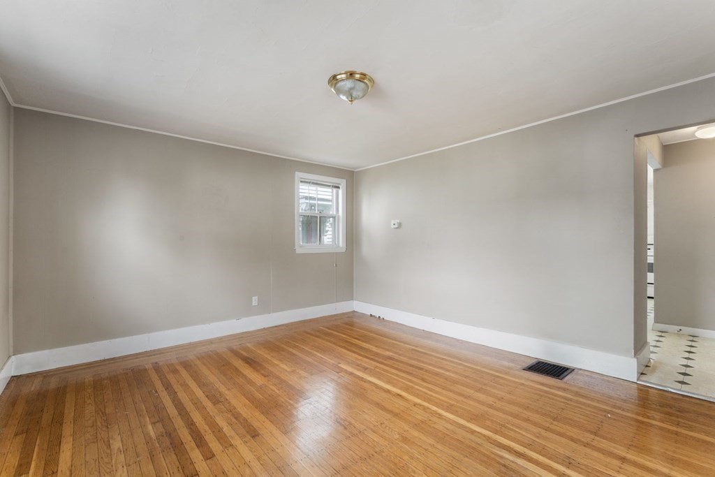24 School Street Newton, MA 02458 - Photo 8 of 13 a view of an empty room with wooden floor and a window