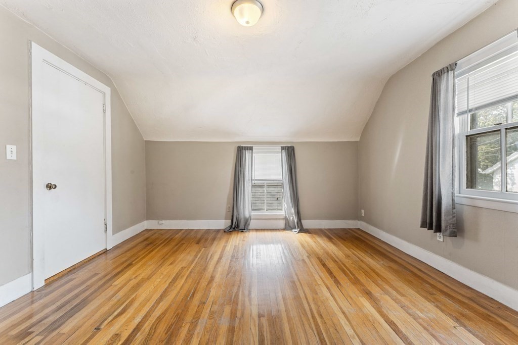 24 School Street Newton, MA 02458 - Photo 9 of 13 a view of an empty room with wooden floor and a window