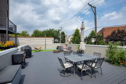 a view of a patio with couches chairs and a yard