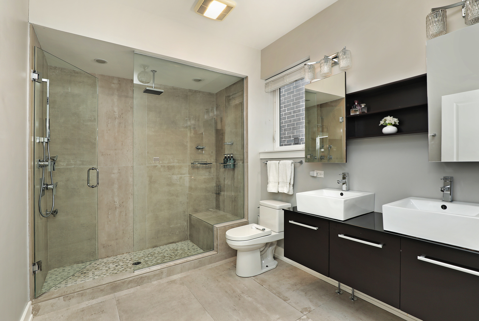 3215 North Elston Avenue, Unit 3N Chicago, IL 60618 - Photo 9 of 21 a bathroom with a double vanity sink toilet and shower