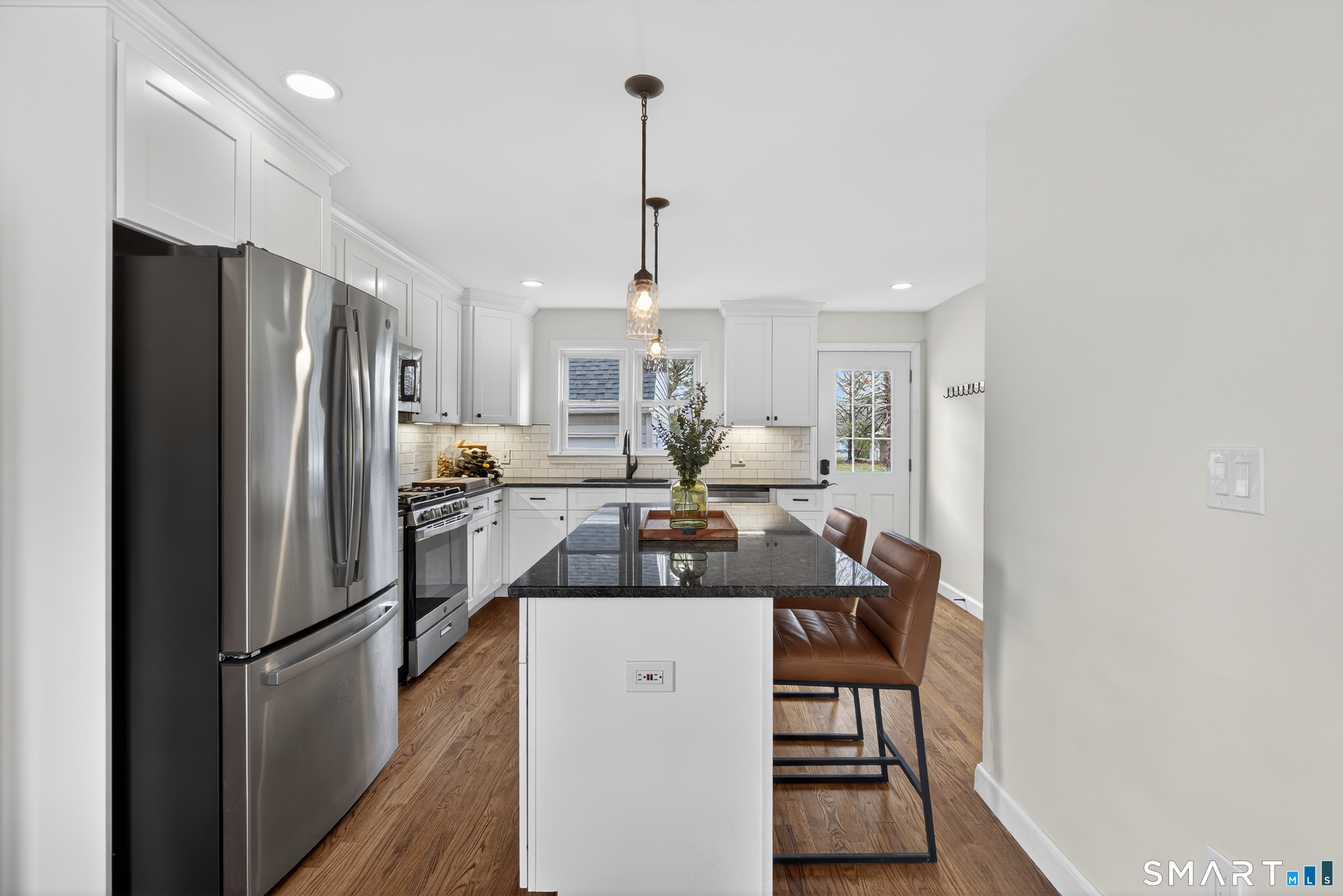 45 Walnut Street Milford, CT 06461 - Photo 13 of 39 a kitchen with refrigerator a stove and a wooden floor