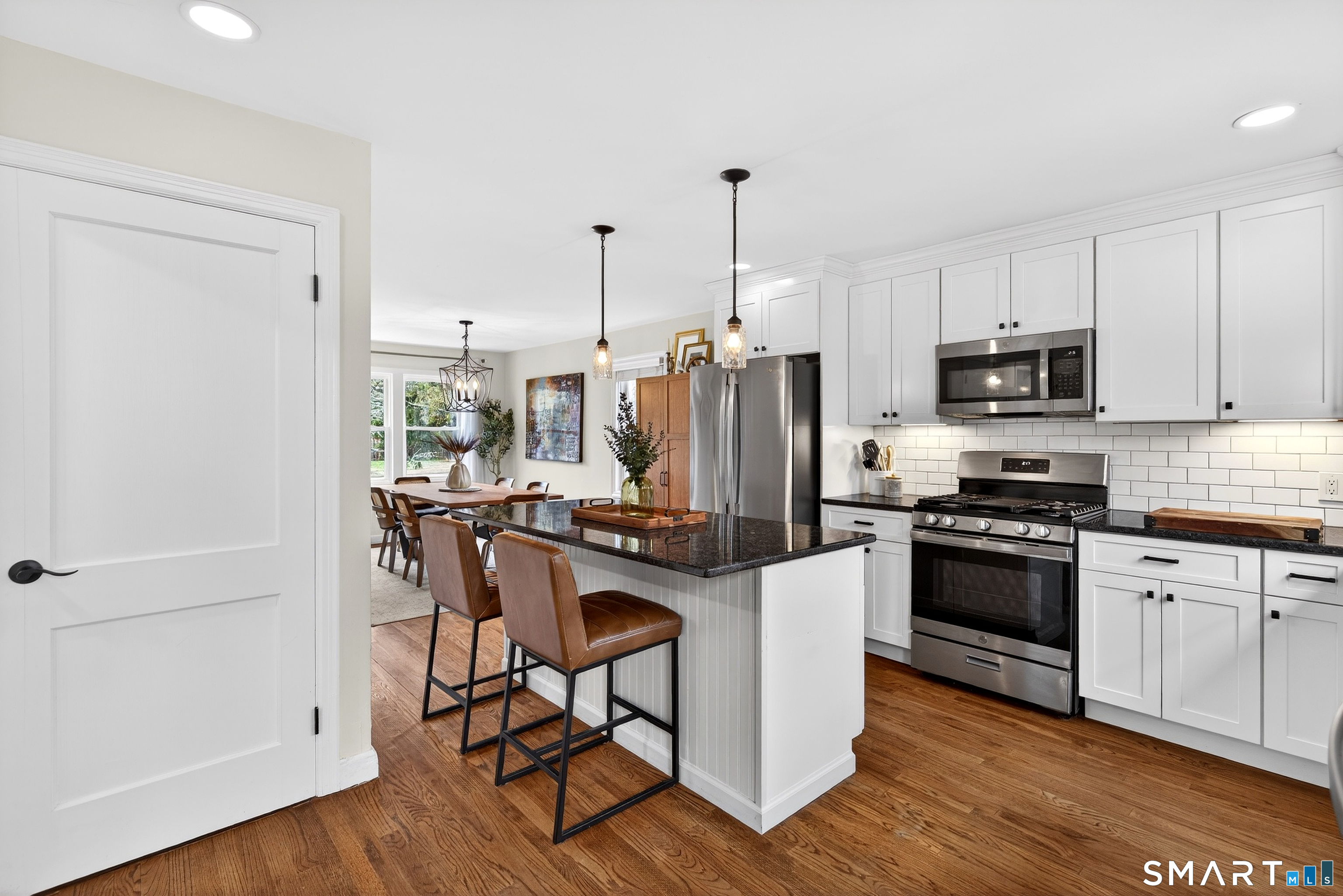 45 Walnut Street Milford, CT 06461 - Photo 14 of 39 a kitchen with stainless steel appliances a stove a sink a refrigerator a dining table and chairs
