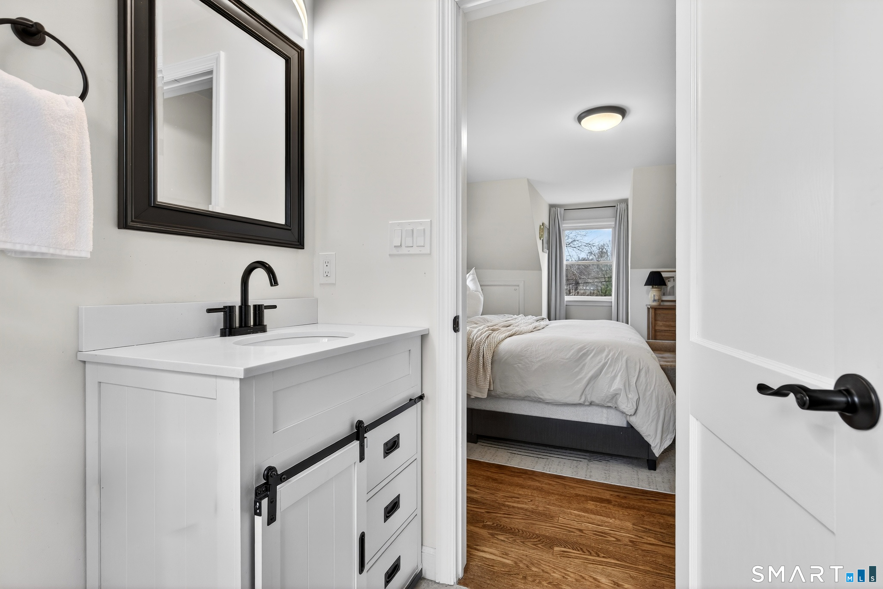 45 Walnut Street Milford, CT 06461 - Photo 24 of 39 a en suite bathroom with a sink and a mirror