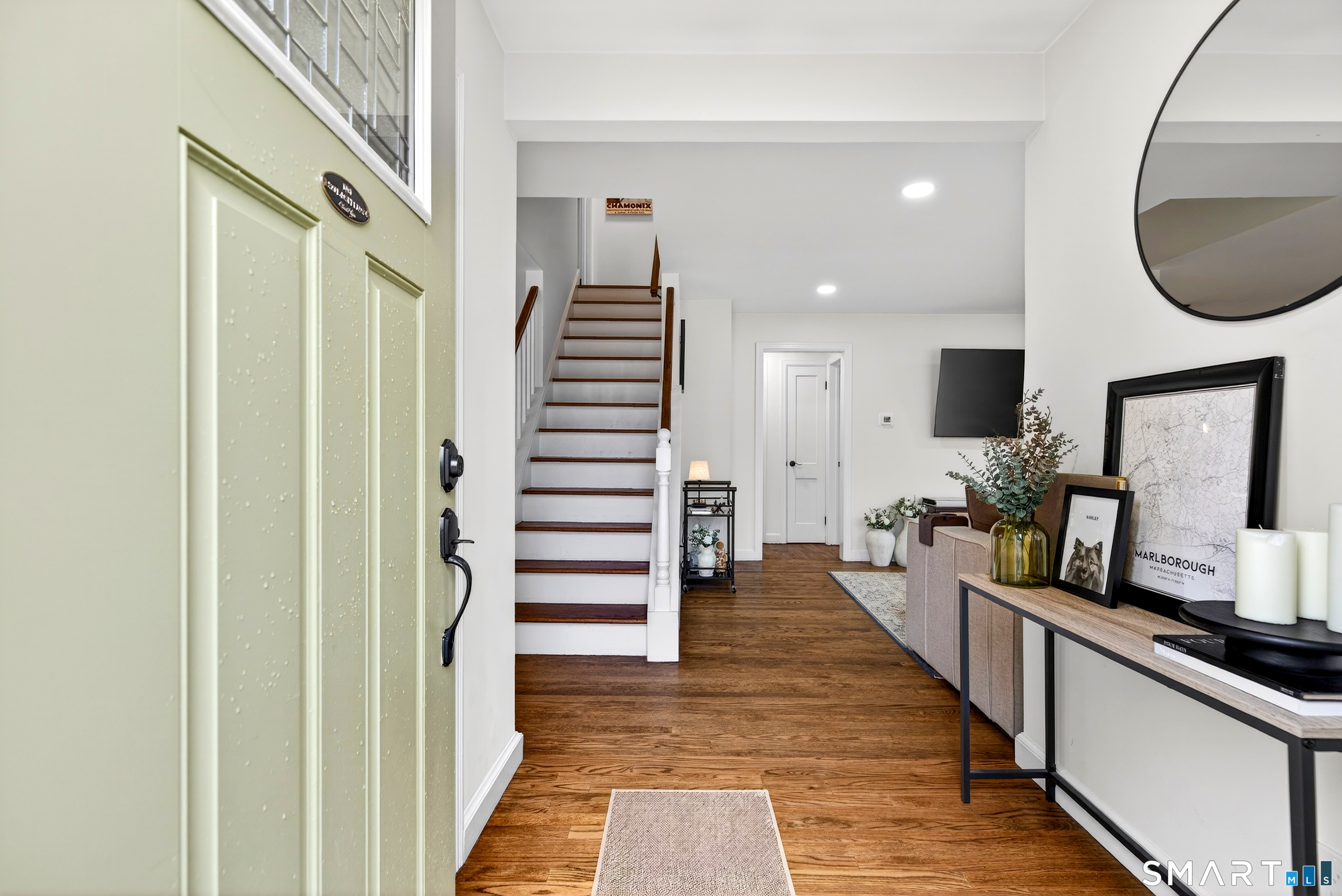 45 Walnut Street Milford, CT 06461 - Photo 4 of 39 a very nice looking room with wooden floor and stairs