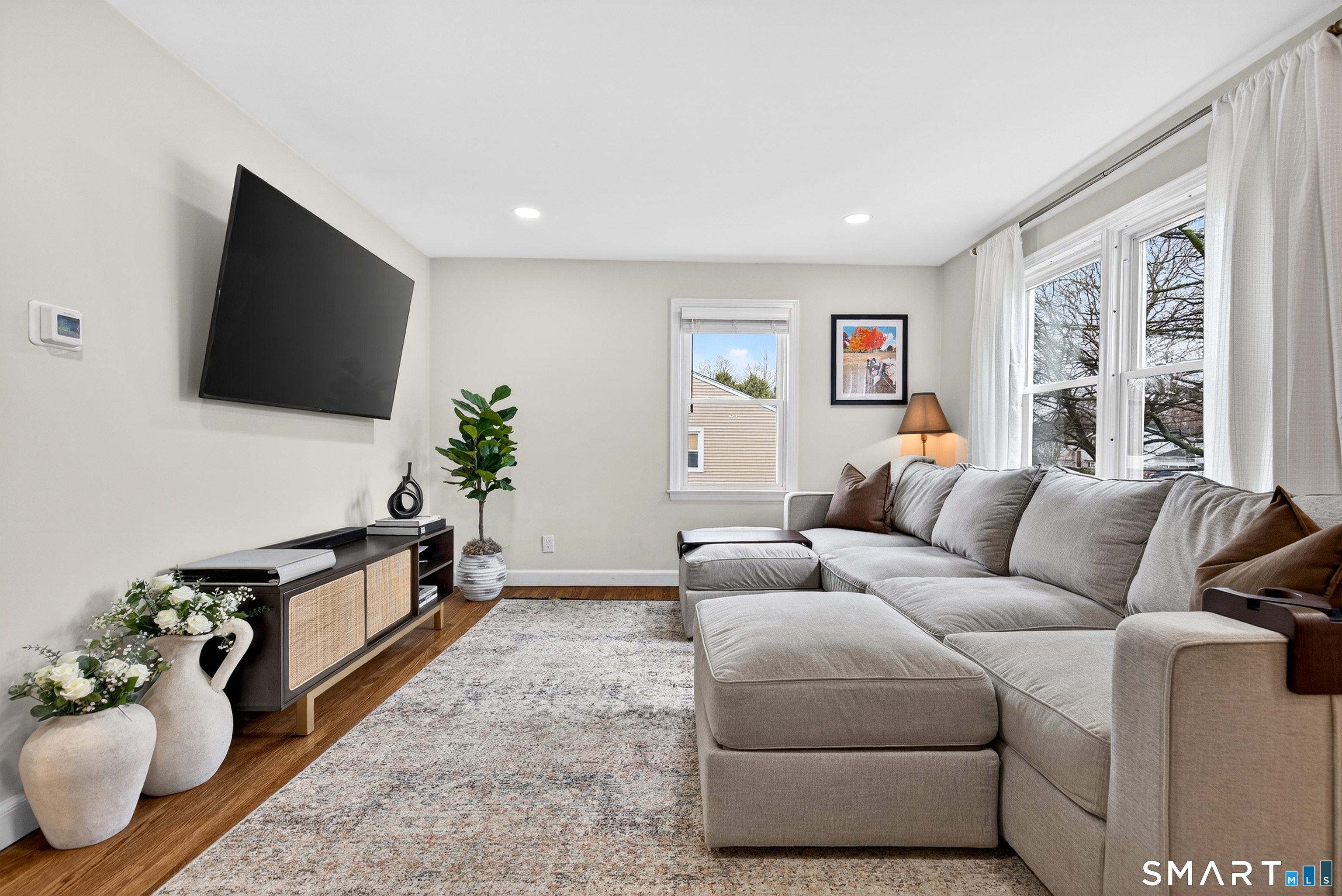 45 Walnut Street Milford, CT 06461 - Photo 5 of 39 a living room with furniture and a flat screen tv