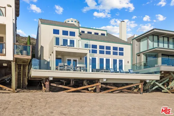 a view of a building with swimming pool and sitting space