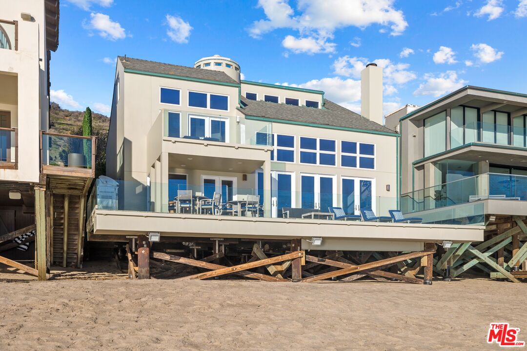a view of a building with swimming pool and sitting space