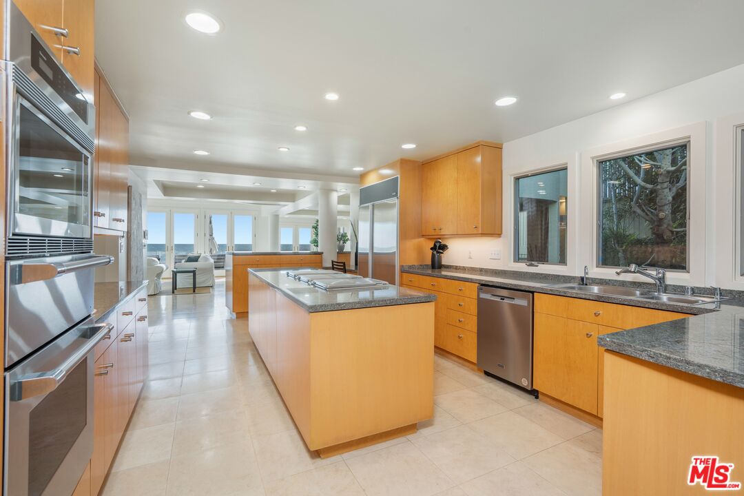 24456 Malibu Road Malibu, CA 90265 - Photo 11 of 33 a kitchen with stainless steel appliances granite countertop sink stove and refrigerator