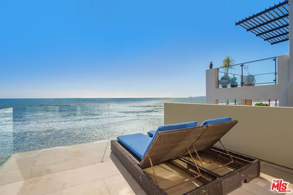 a bedroom with a large bed and a flat screen tv