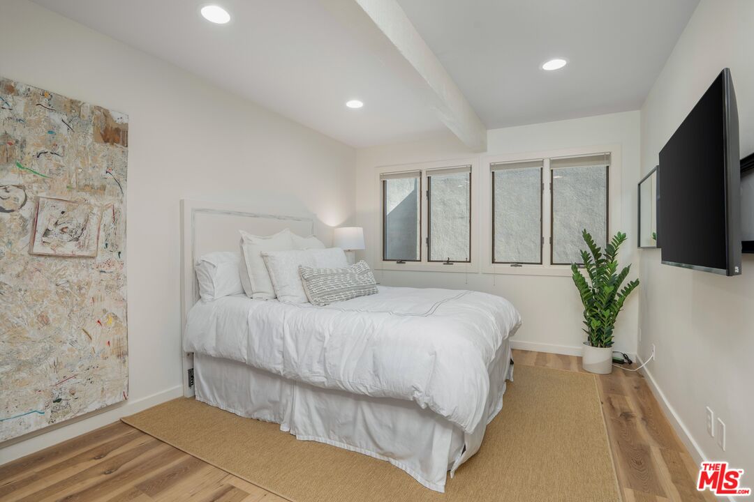 24456 Malibu Road Malibu, CA 90265 - Photo 20 of 33 a bedroom with a large bed and a flat screen tv