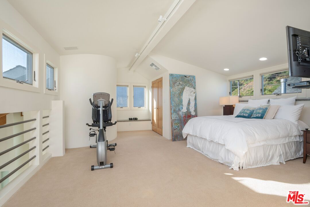 24456 Malibu Road Malibu, CA 90265 - Photo 24 of 33 a bedroom with furniture and a wooden floor