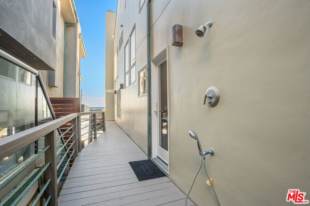 24456 Malibu Road Malibu, CA 90265 - Photo 28 of 33 a view of a hallway with wooden floor and staircase